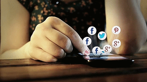 gif que mostra uma mão mexendo no celular, vários ícones de redes sociais começam a pular da tela